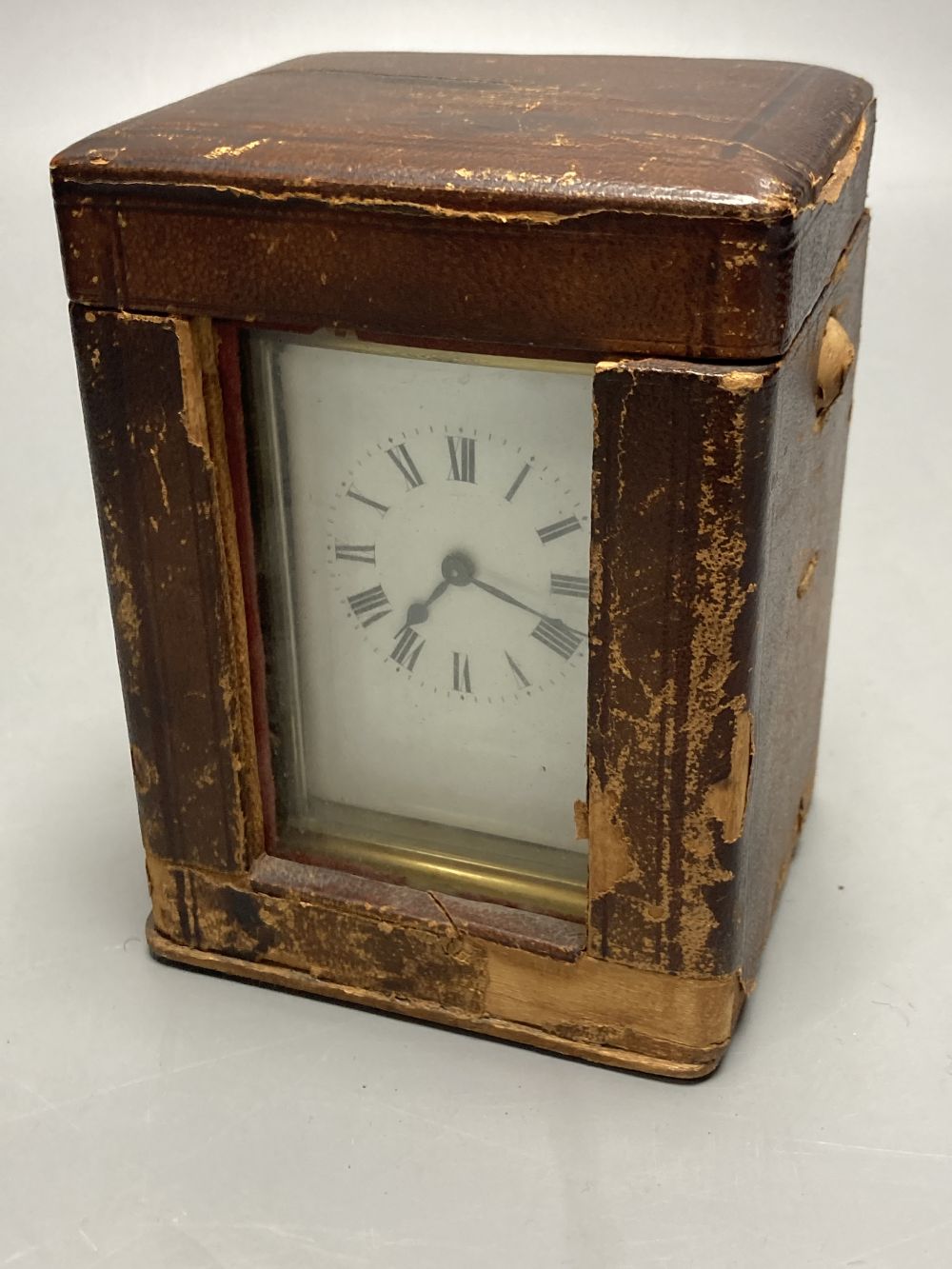 A gilt-brass carriage timepiece, with white enamelled Roman dial and outer travelling case and another carriage clock (2)